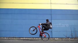 Cool man going fast with crazy Mountainbike Wheelie trick
