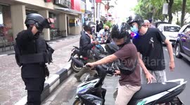 Police in Indonesia city disperse crowds gathering in cafes and restaurants during COVID-19 pandemic