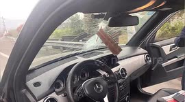 Loose bumper flies into car windshield, almost hitting driver in China