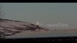 April Super-moon rising over the snow covered Icelandic peaks