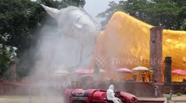 Customised vehicles used to spray sanitising liquid on buildings in Thailand