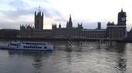 Londoners jogging along the river Thames promenade with magnificent views onto the Houses of Parliament and Westminster Bridge