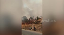 Panicked children run from raging forest fires in Laos