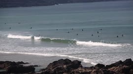 Surfers ignoring social distancing by taking to the waves at popular beach during UK lockdown
