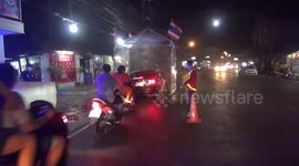 Sanitising tunnel sprays vehicles passing through Thailand city