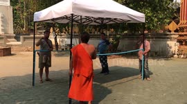 Buddhist monks in Thailand make disinfecting tunnel