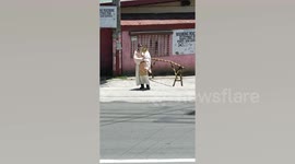 Filipino catholic priest blessses at a distance during lockdown