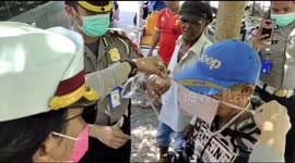 Indonesian police distribute masks and hand sanitizer