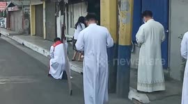 Filipino priest carries cross for Good Friday despite coronavirus fears
