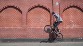 Action / Extreme / Fun Sports: BMX Bike rider in urban location does tricks