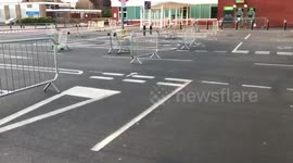 ASDA staff use trolleys to make crowd control barriers during Good Friday shopping chaos