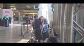 US customs agent seen aiding a homeless man without mask or gloves