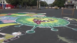 Indian artists paint coronavirus graffiti on roads to encourage people to stay home
