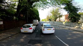 Dangerous driver almost hits pedestrian then stops to talk with dodgy registration plate mate