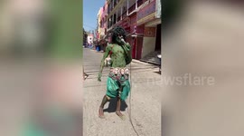 Man dressed as 'coronavirus' urges people to stay indoors, follow lockdown norms in northern India