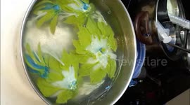 Vietnamese woman creating 3D blue daisies flowers in the gelatin cake