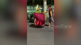 Father and son push statue of Jesus for Easter in Manila