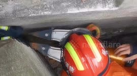 Chinese firefighters free children from narrow gap between walls after they get stuck while playing hide and seek