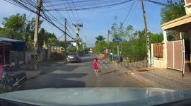 Heart-stopping moment young girl runs out in front of car narrowly avoiding being run over