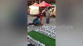 Market seller gives boy a free pair of shoes