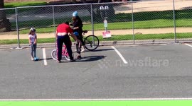 Dad’s pants are falling down as he teaches his son how to ride a bike in Santa Monica, California.