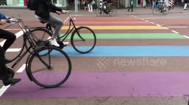 Cyclists cross a rainbow crossing in Utrecht, The Netherlands