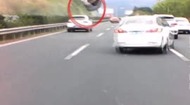 Tyre narrowly misses vehicles on Chinese highway after dropping from truck