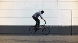 Extreme Sports: BMX Bike rider jumps 180 does fakie jump and turns back again