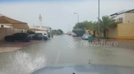 Vehicle drives through flooded street after heavy rainfall hits Qatar
