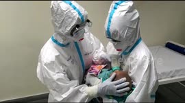 Nurses in Indian hospital care for baby whose mother tested positive for COVID-19