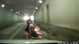 Woman pushing stroller in Chinese tunnel narrowly escapes being crushed by car