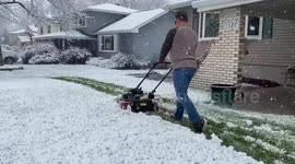 US man continues to mow lawn after surprise spring snowfall hits Nebraska
