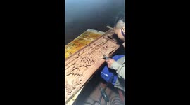 The man creates wooden pictures with many beautiful motifs from the wood