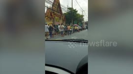 Hundreds of Bangkok residents queue for food handouts during COVID-19 economic slump