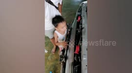 Toddler rescued after getting his finger stuck in car bumper