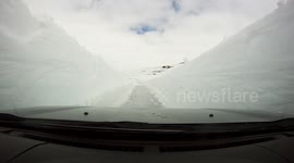 Swedish photographer drivers through six-metre-high walls of snow