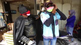 Activist dressed as Batman hands out free face masks during COVID-19 pandemic in Indonesia