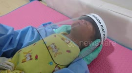 Newborn babies wear face shields to protect them against coronavirus at Indonesian hospital