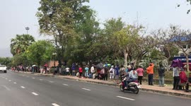 Hundreds of struggling locals queue for food handouts in northern Thailand