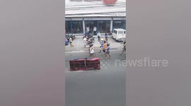Filipino motorcyclists are punished to walk along streets with helmets after being caught riding without protective gears