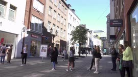 Some people form a queue in front of a shop after smaller shops in germany were allowed to open again this monday.