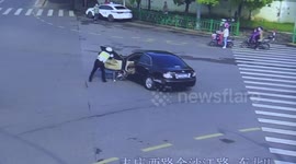 Chinese policeman stops driverless car after it threw motorist out onto road