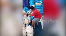 Disabled Filipino man helps to pack food parcels during Covid-19 pandemic