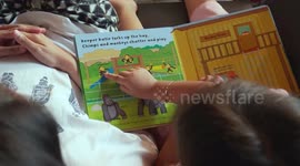Mom Is Tired But Still Accompany Her Reading The Book While Her Nanny Feed Her
