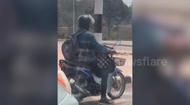 Kitten Rides In Motorcyclist's Lap In Thailand