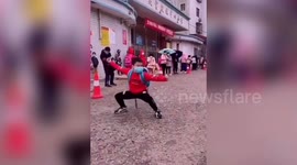 Excited Chinese student performs martial arts routine at school's gate on reopening day