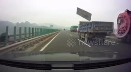 Flying plank smashes car windscreen after falling off truck on Chinese highway