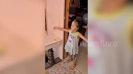 Filipino toddler mimes a hug to her policeman father during coronavirus pandemic