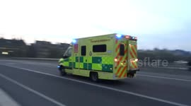 London ambulance speeding along Westminster Bridge with lights and sirens on