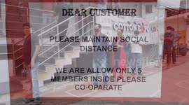Indians line up infront of a grocery mart standing in circles and at least a metre away to purchase their groceries in Bengaluru, Southern India.